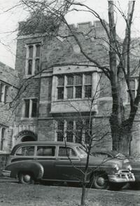 Exterior of Rhoads Hall with parked  car