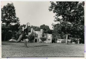 Student playing frisbee on Merion Green