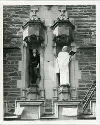 Students pretending to be statues on top of Thomas Great Hall main entrance