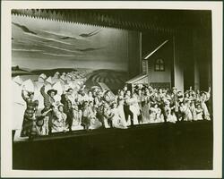 Oklahoma! : wide shot of cast from house