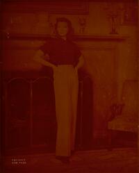 The Philadelphia Story : character portrait of Katharine Hepburn as Tracy Lord, standing before fireplace