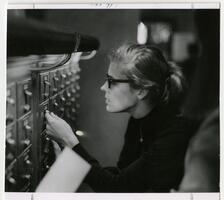 Student using card catalog in Thomas Library.