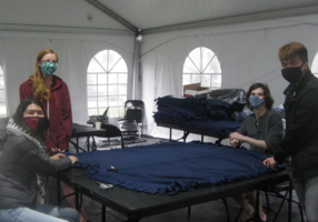 Four students posing with blanket photograph