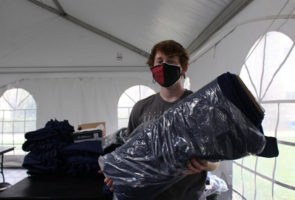 Student holding wrapped fabric or blanket photograph