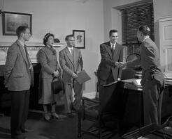 Gilbert White shaking hands with the father of a prospective student