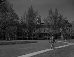 A student walking toward Founders Hall