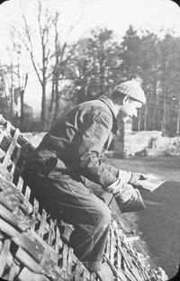 Salvaging tiles from a ruined roof.