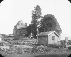 Hut in front of ruined chateau.