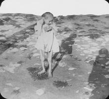 Child wasted by famine standing along Volga.