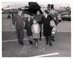 [untitled item; photo of Viet children and adults outside of airplane]